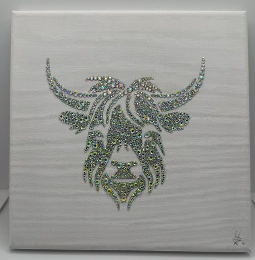 Decorative wall art with a stylized face design made of rhinestones on a white background