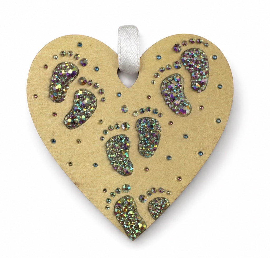 Heart-shaped ornament with crystal footprints on a yellow background